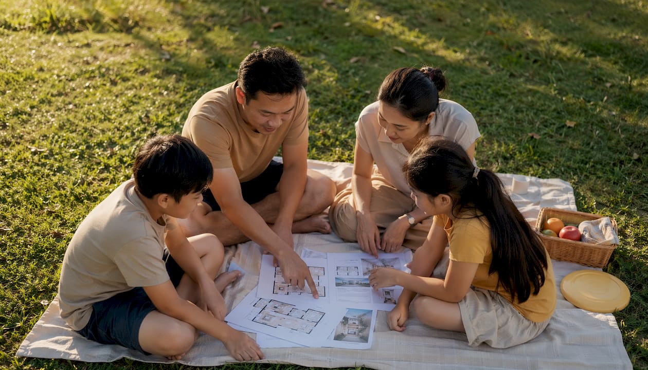 Family reviewing condo floor plans at table