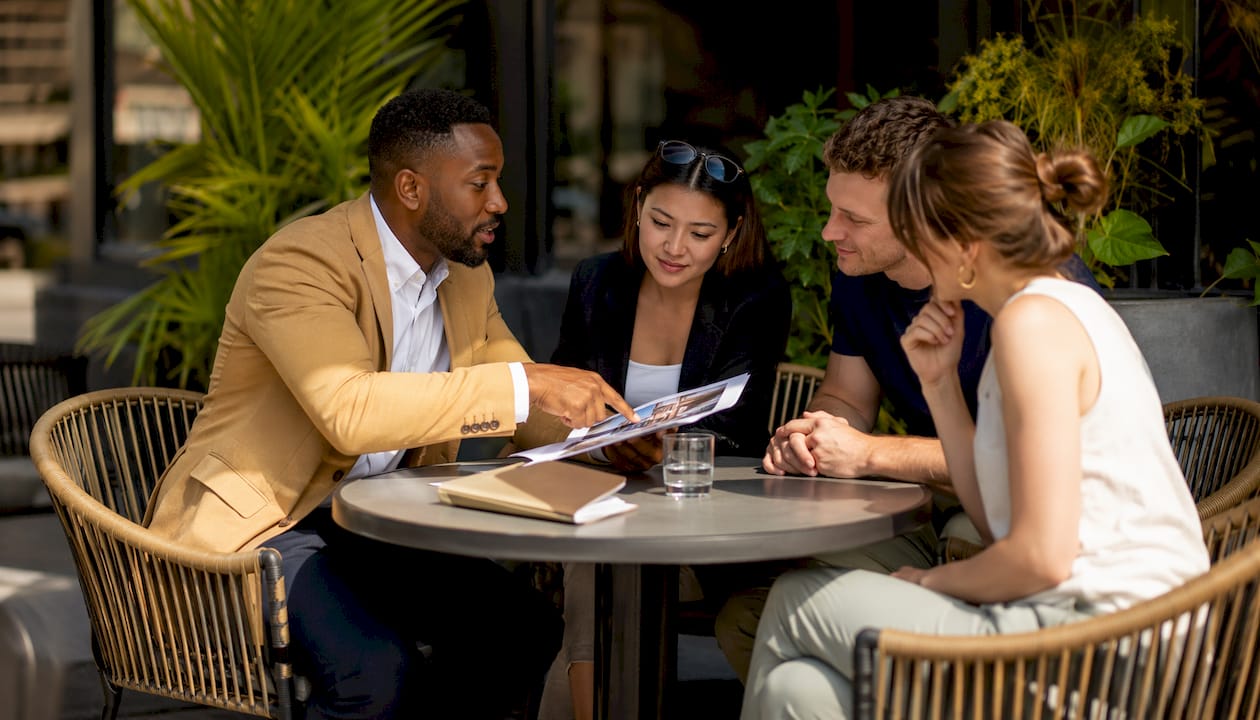 Luxury real estate agent consulting young buyers